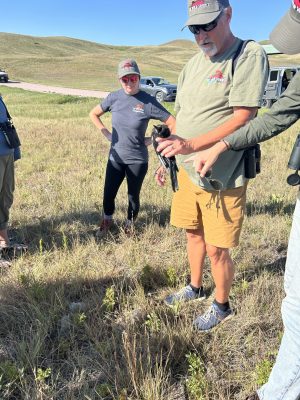 The Wild Source owner, Bill, explaining how prairie falcon kill their prey  (Photo Credit: Katt Hendershot)